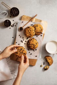 top view hands holding chocolate chips cookie